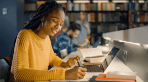 Woman writing with laptop- AI-Media