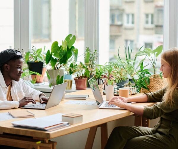 people in co working space on laptop