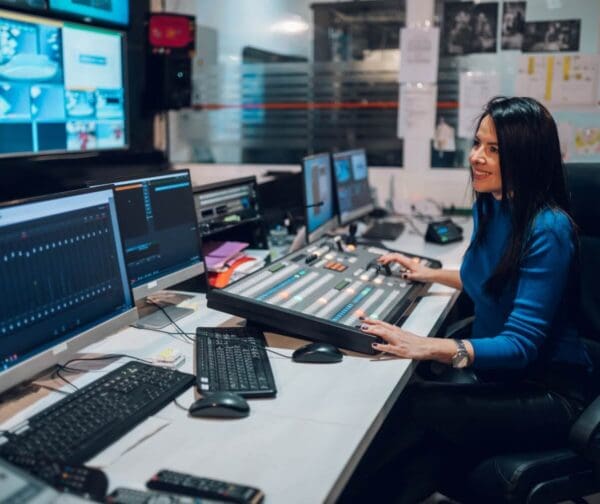 woman using equipment in broadcast control room